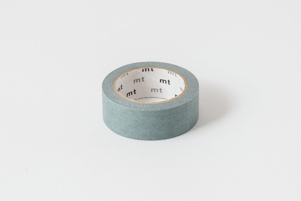 A roll of matte gray washi tape on a white background, with the brand 'mt' visible on the tape.