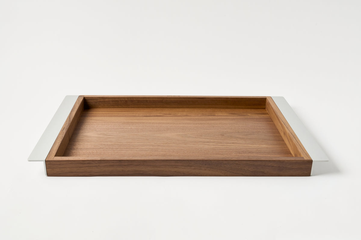 Wooden tray with white rim on a light gray background
