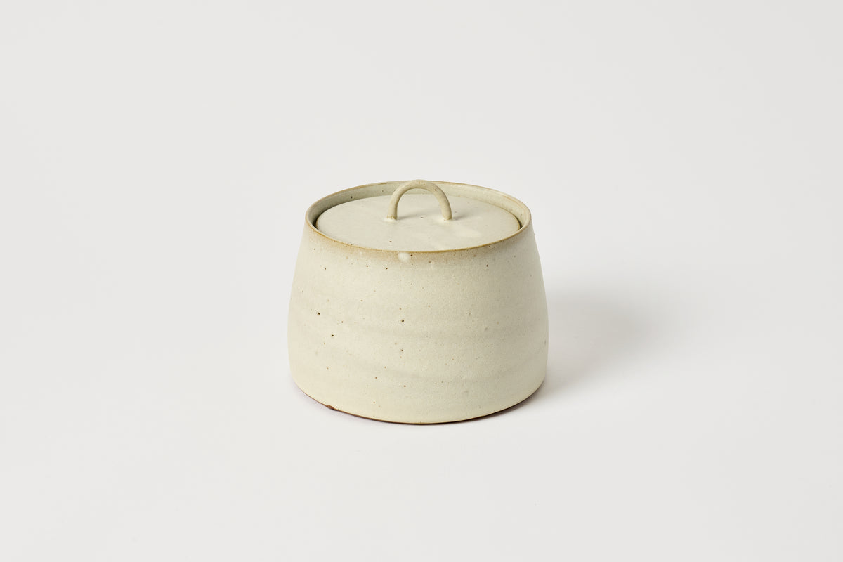 Ceramic jar with a lid on a white background