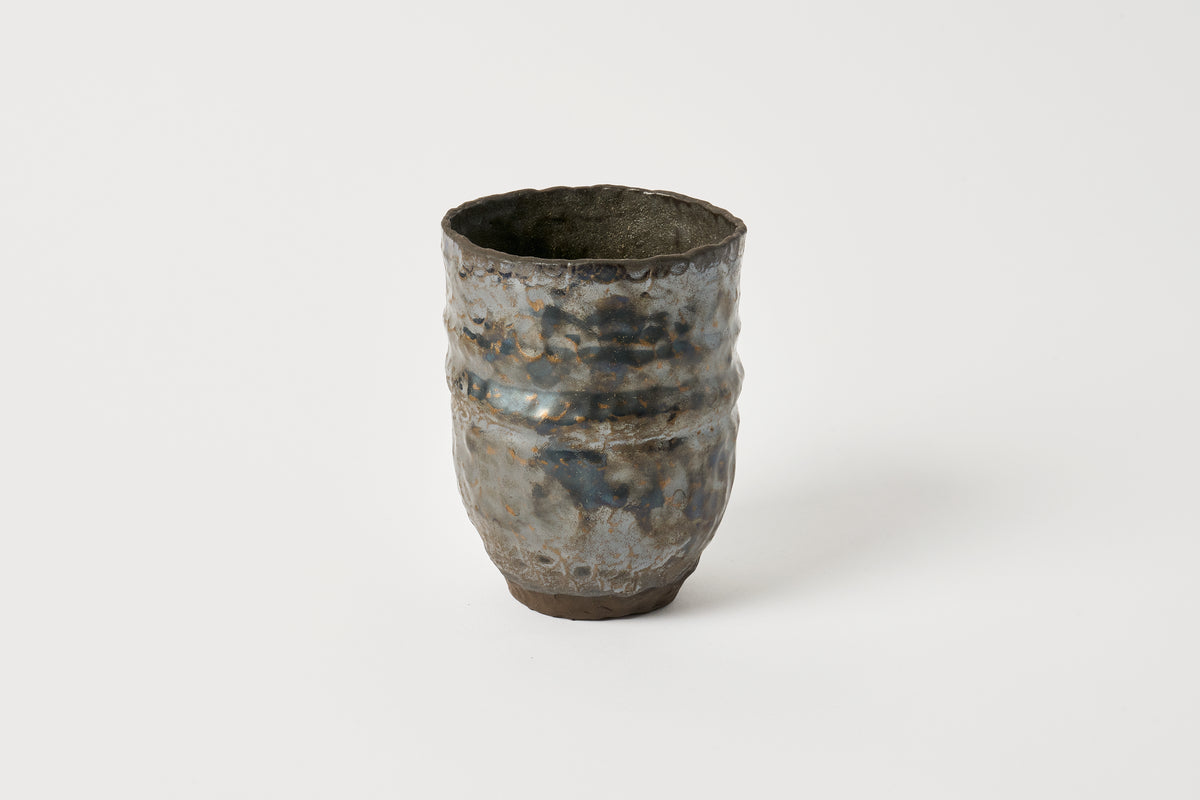 Textured ceramic cup on a white background