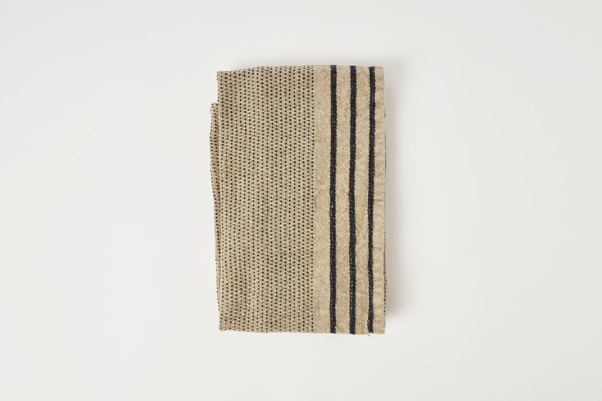 Textured fabric with black stripes on a white background