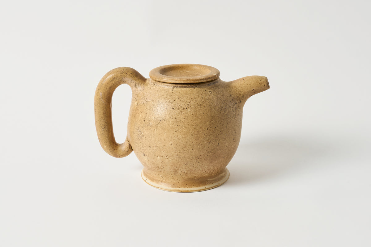Brown ceramic teapot on a white background