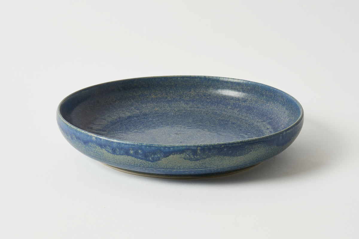 Blue ceramic plate on a white background