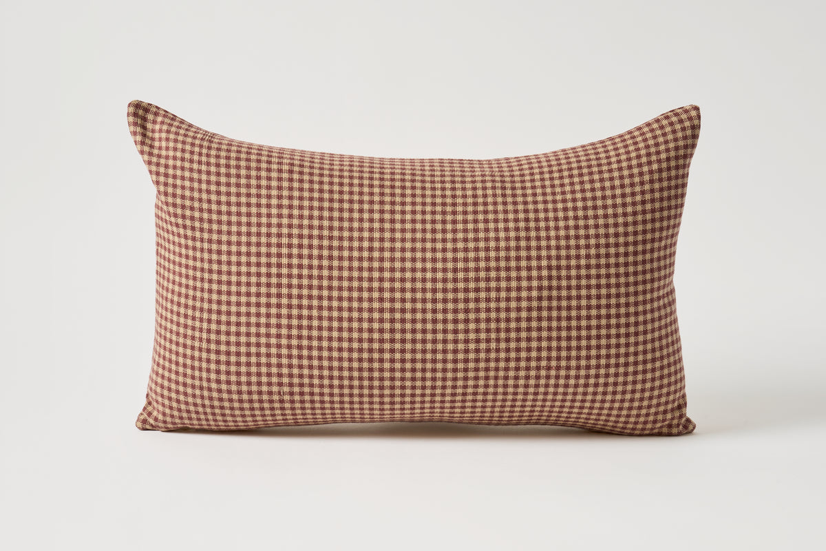 A rectangular lumbar pillow with a brown and beige gingham checkered pattern, shown against a plain light gray background.