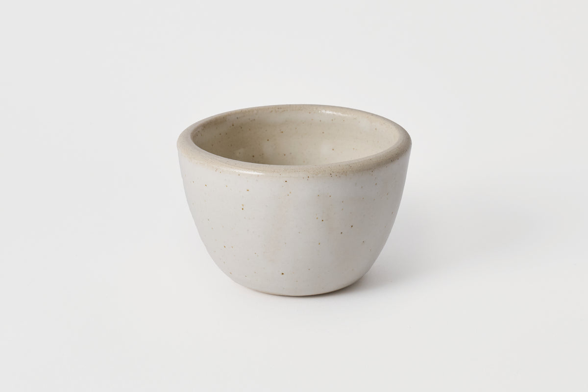 Ceramic bowl with speckled texture on a white background