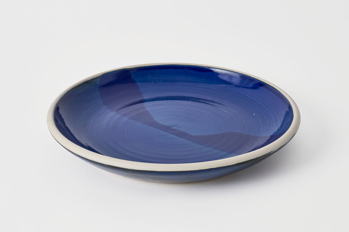 Blue ceramic plate on a white background