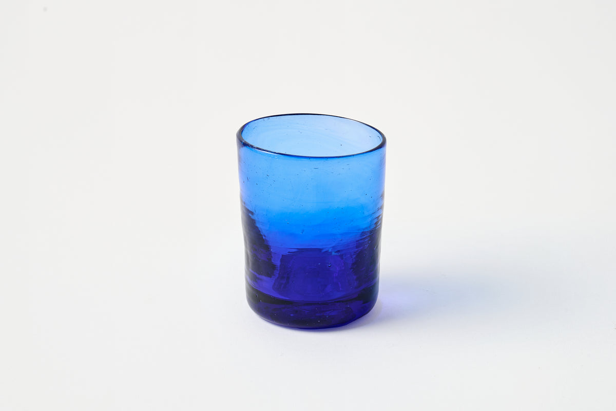 Blue glass tumbler on a white background