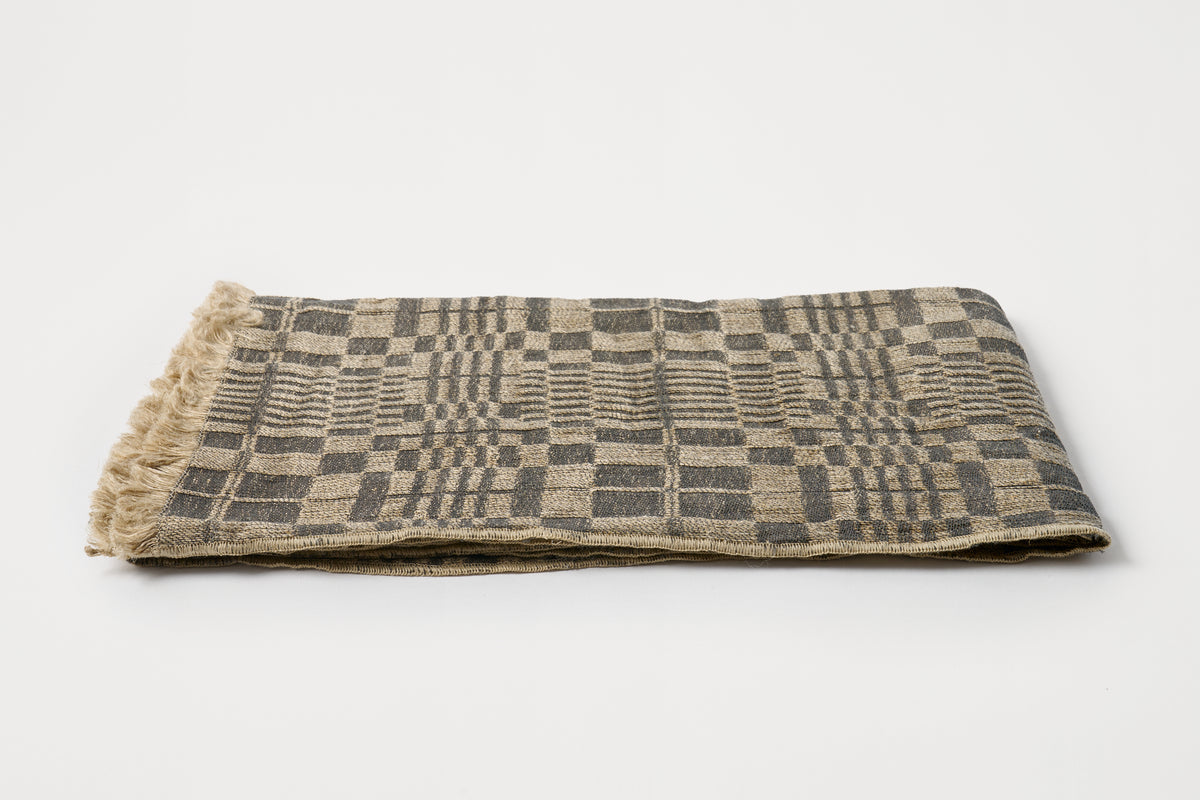 Folded fabric with a geometric pattern on a white background