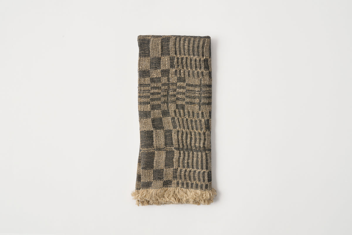 Black and gray patterned napkin on a light gray background