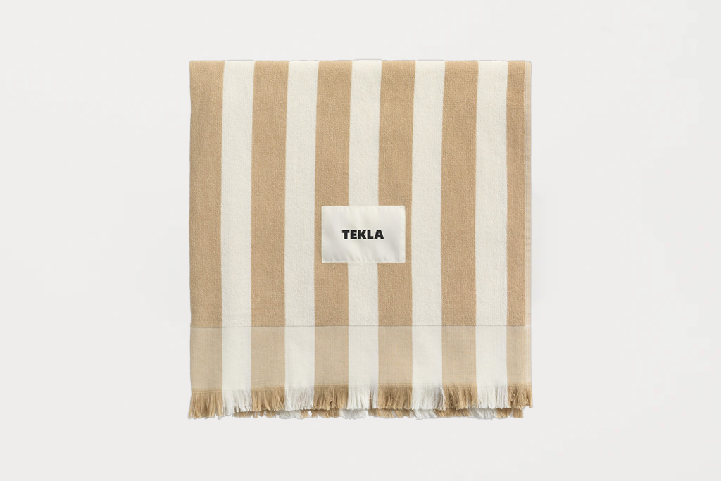 Striped towel with 'TEKLA' label on a white background