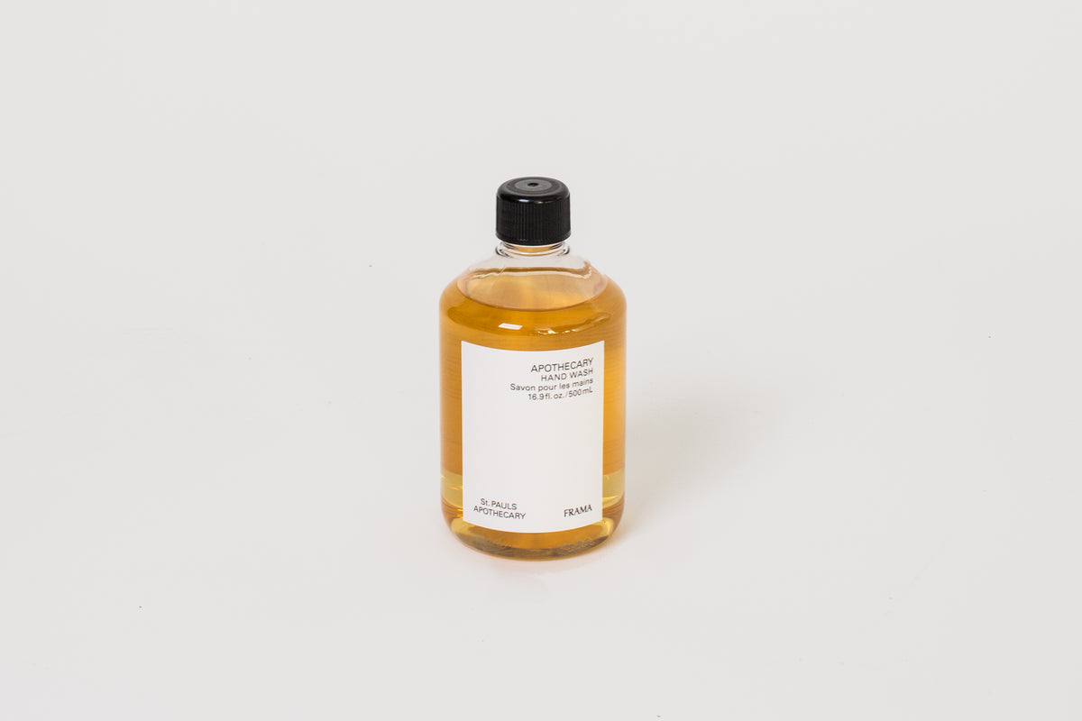 A clear bottle of hand wash with a yellowish liquid inside, labeled 'FRAMA APOTHECARY', on a white background