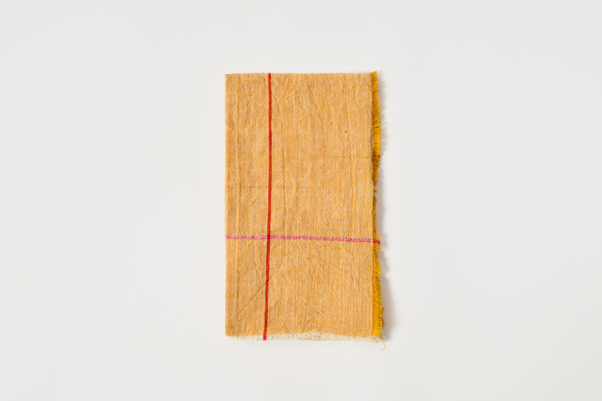 Yellow napkin with a red stripe on a white background