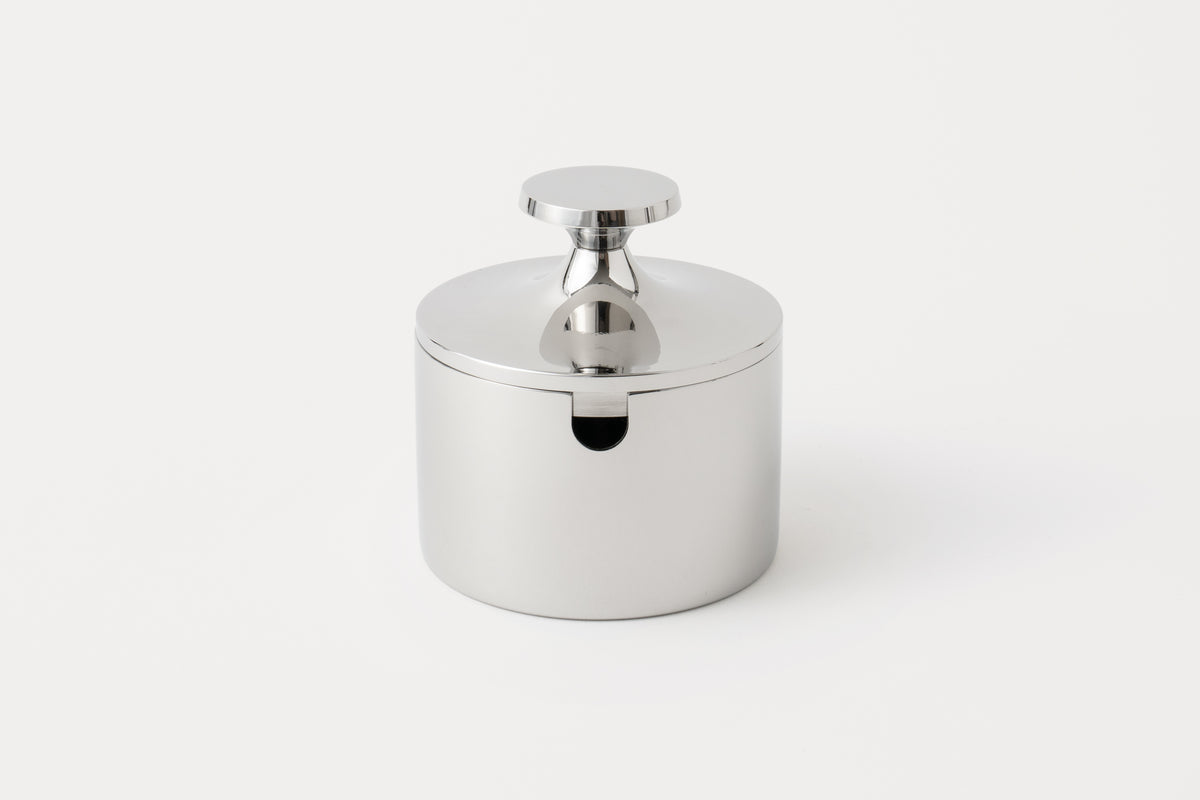 A stainless steel sugar pot with a lid and handle, displayed against a white background.