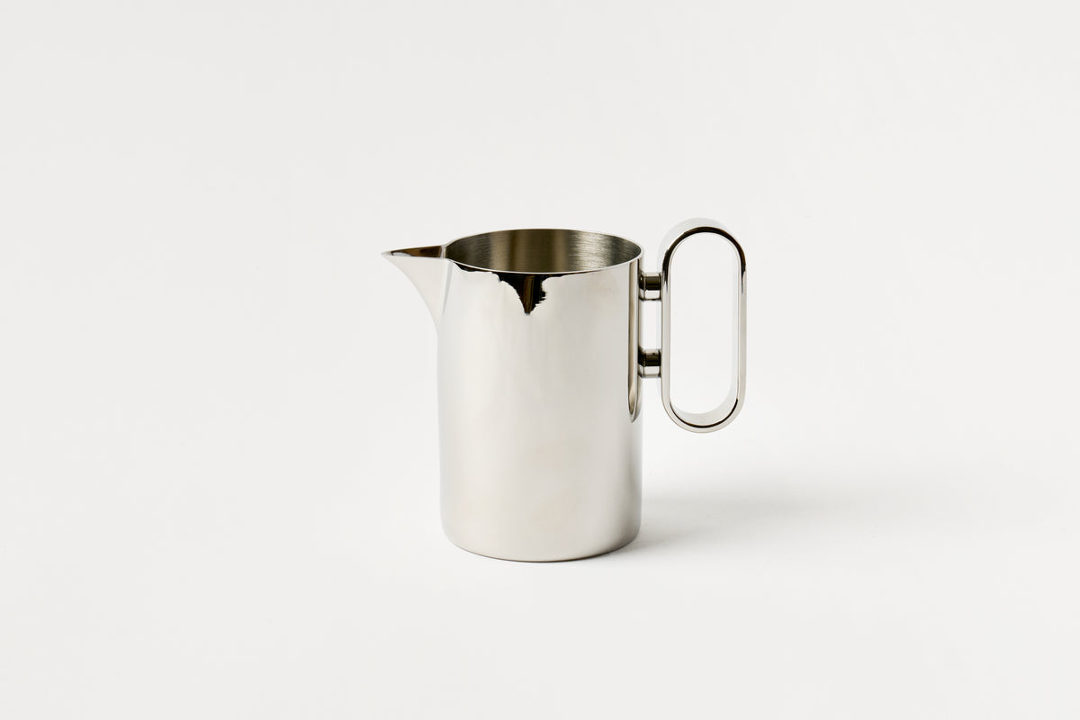 Silver milk pitcher on a white background