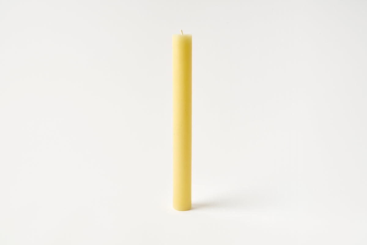 Yellow candle on a white background