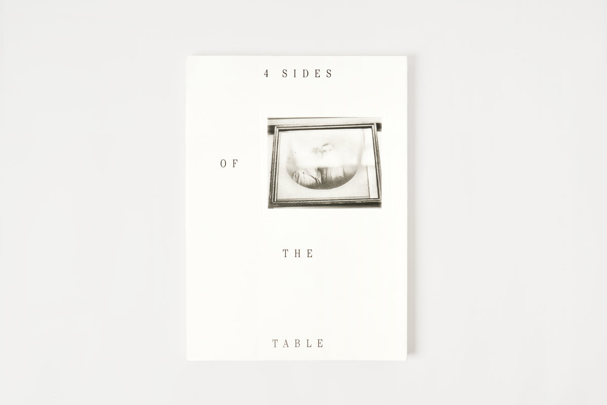 A book with text '4 SIDES OF THE TABLE'.