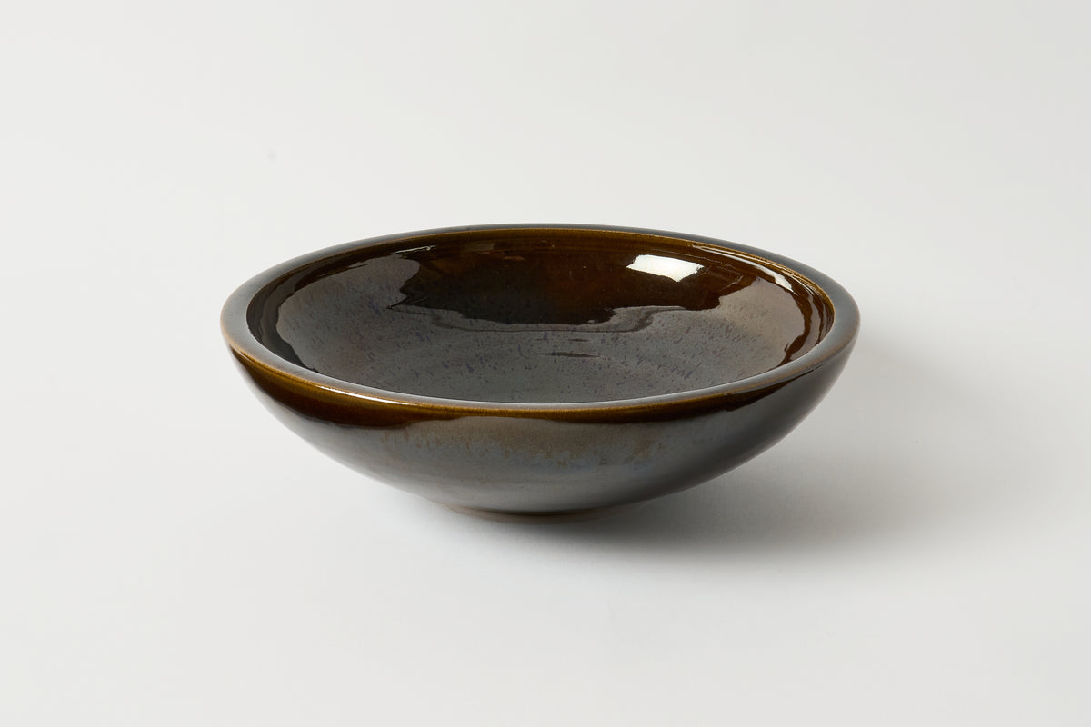 Brown ceramic bowl on a white background