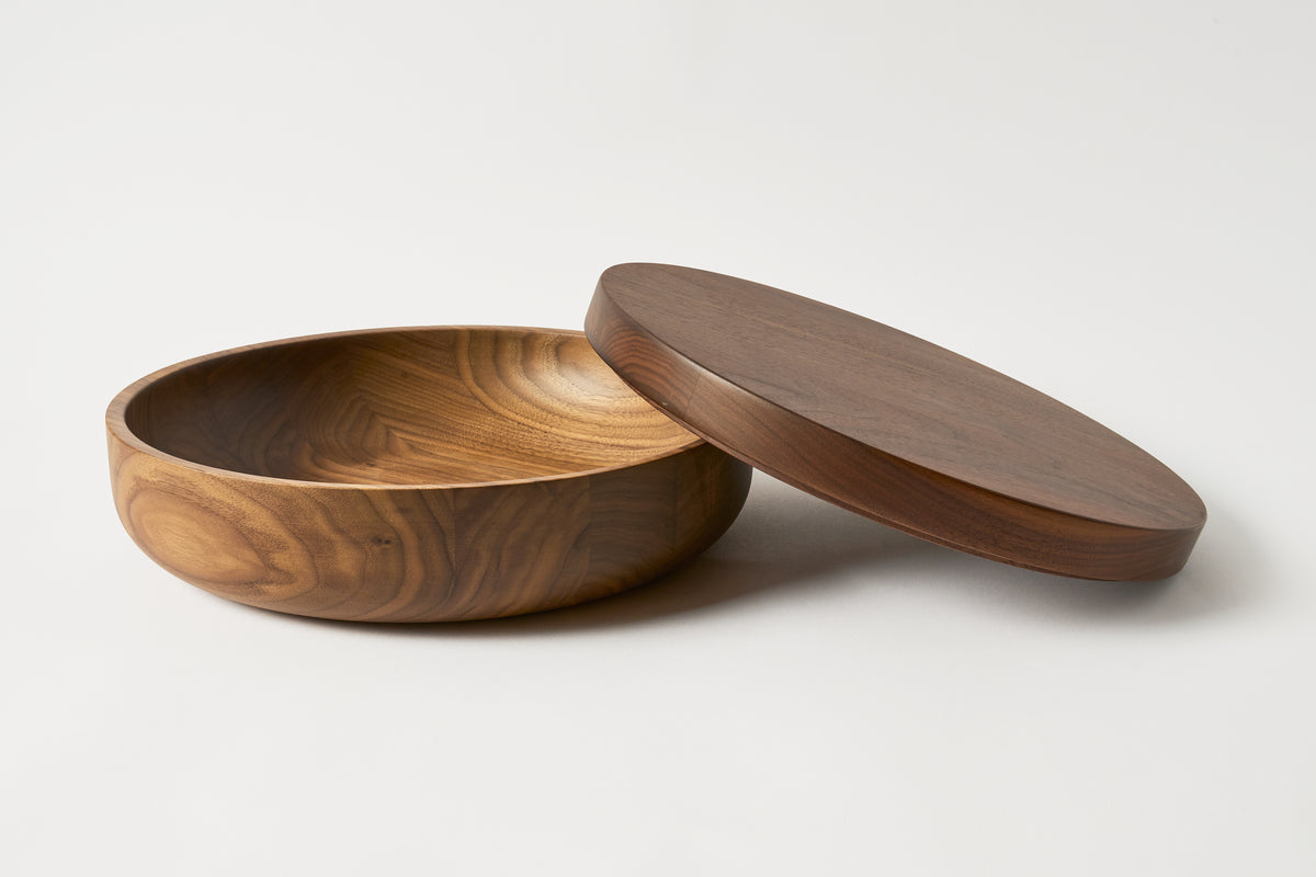Wooden bowl with a lid on a white background