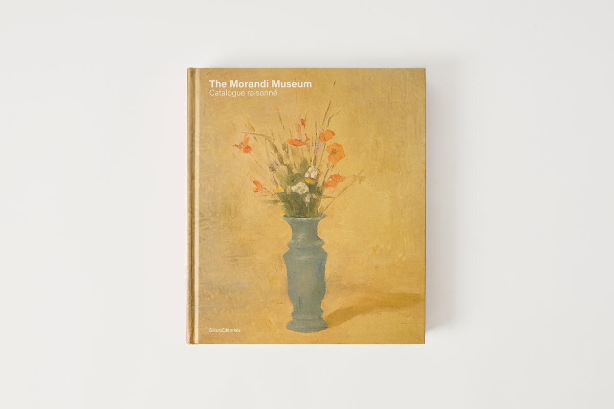 Book cover of 'The Morandi Museum' with a vase and flowers illustration on a beige background