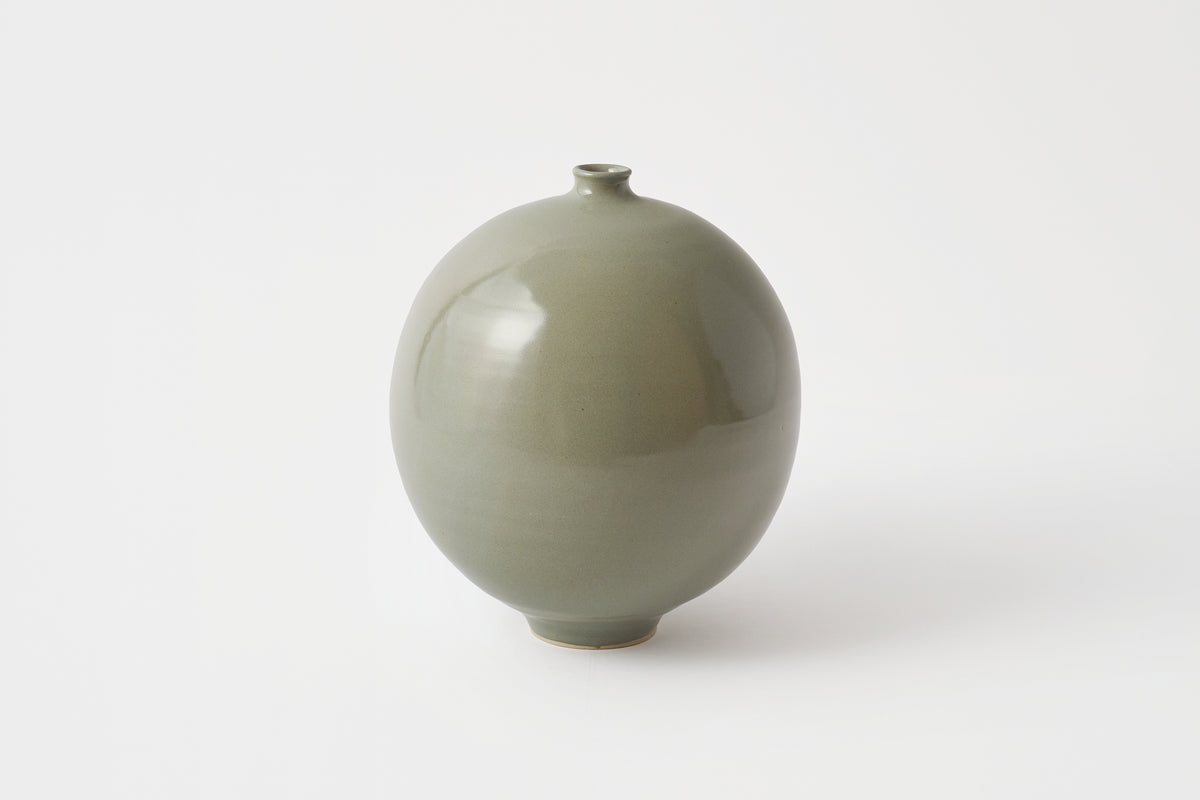 Green ceramic vase on a white background