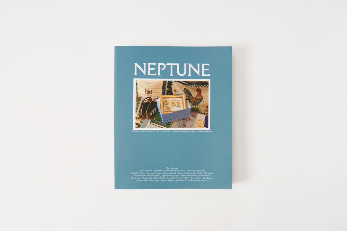 A hardcover book titled 'NEPTUNE' in white lettering on a muted blue cover, featuring a central collage of vintage space-themed illustrations and photographed against a clean white background.