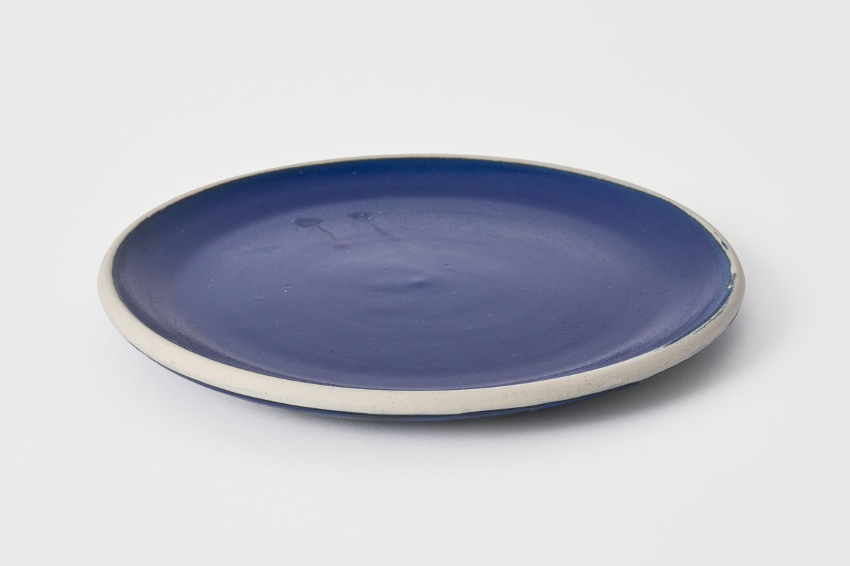 Blue ceramic plate on a white background