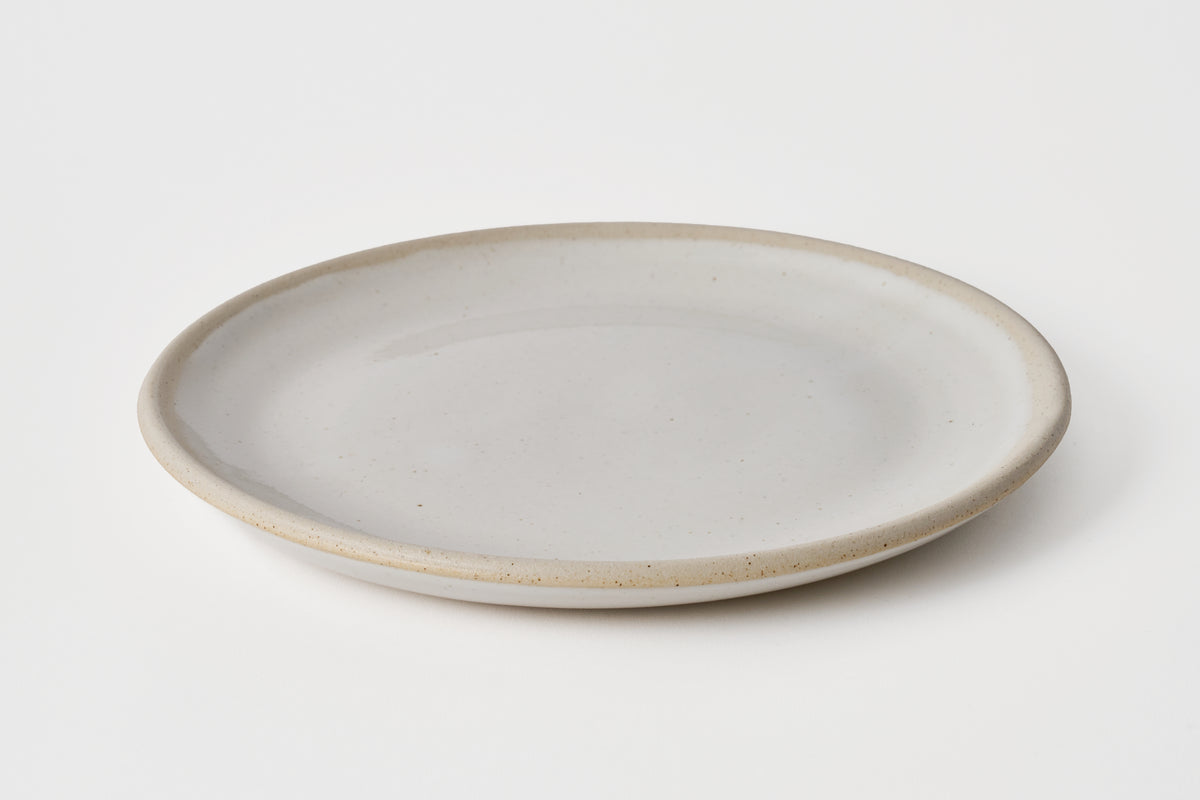 Ceramic plate with a light gray finish on a white background