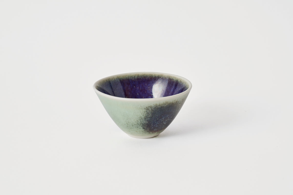 Green and purple ceramic bowl on a white background