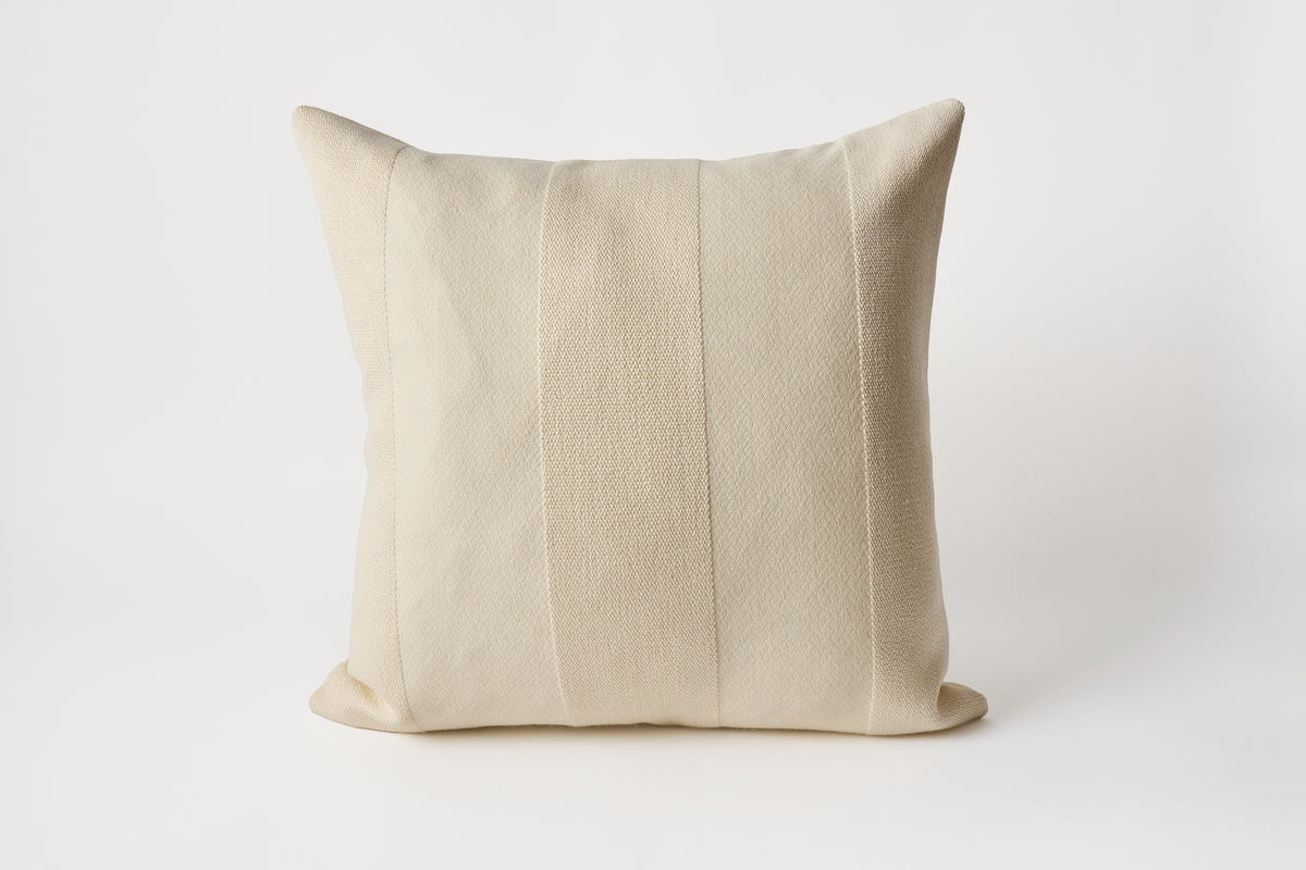 Beige pillow on a white background