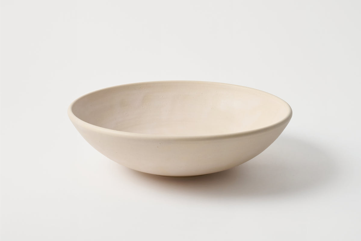 Beige ceramic bowl on a white background