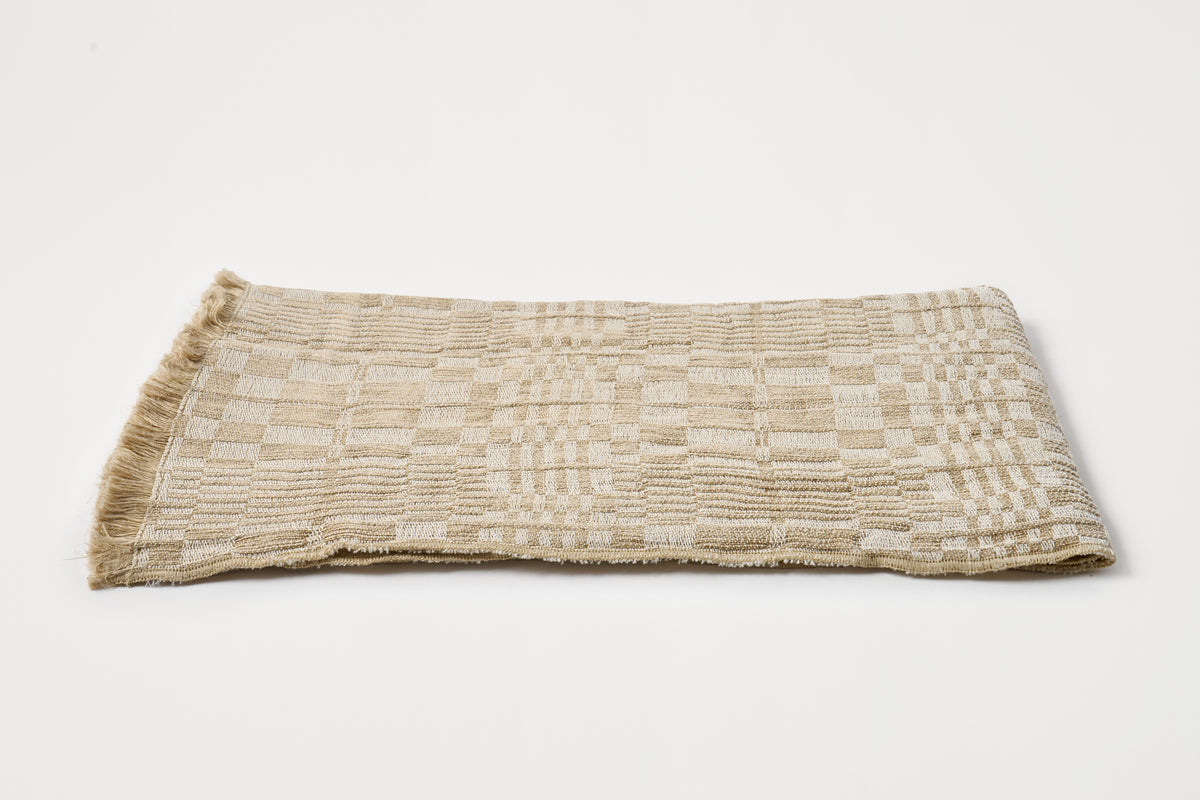 Textured woven napkin on a light gray background