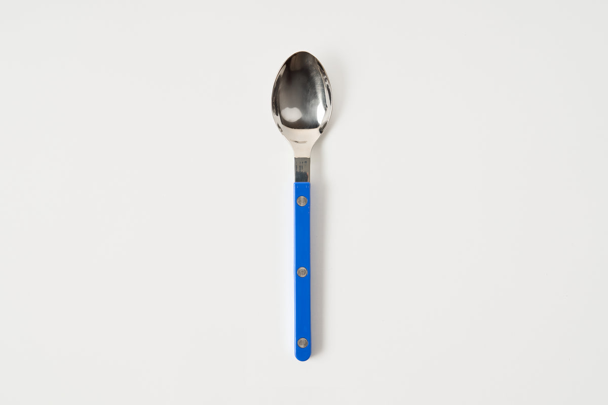 Spoon with a blue handle on a white background